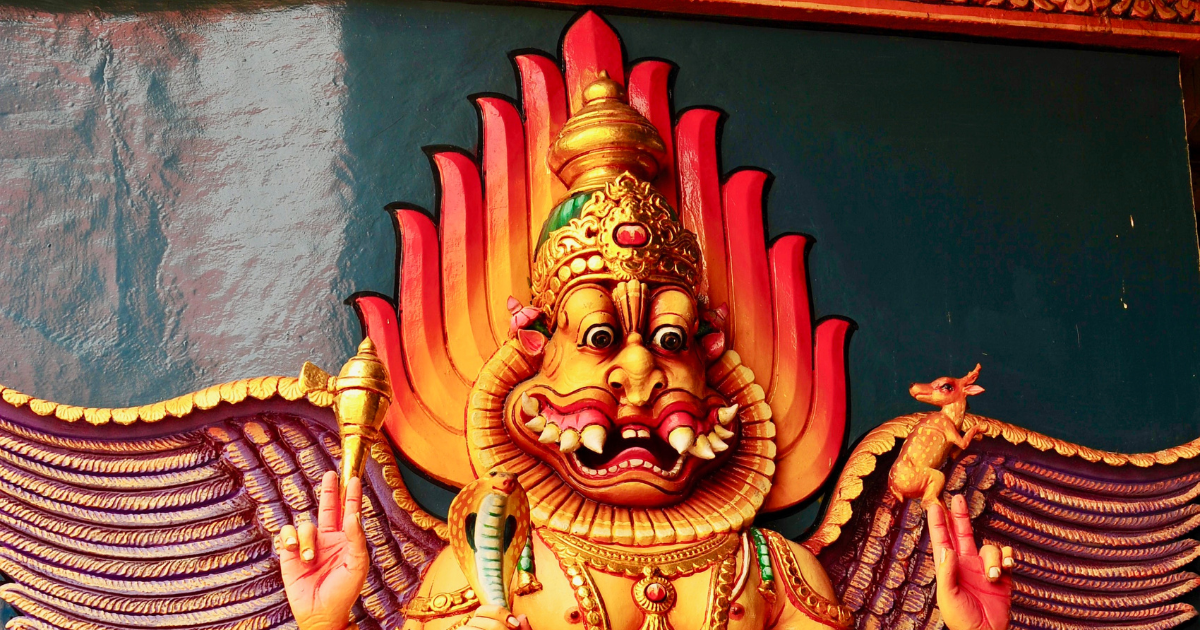 Lion-Headed God Narasimha in orange and yellow colour with a dark green background